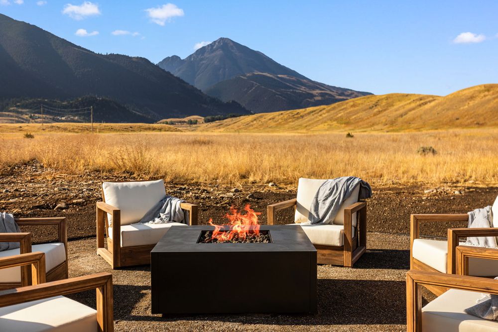 Fire pit with teak lounge chairs and the mountains behind
