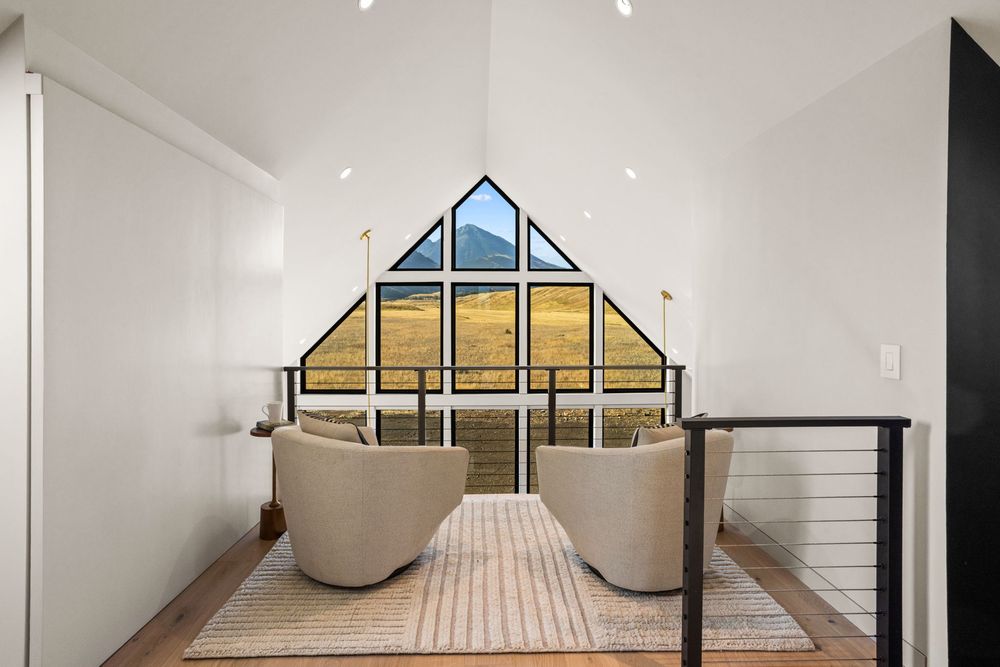 The loft sitting area looking out through the gable glass at the mountains