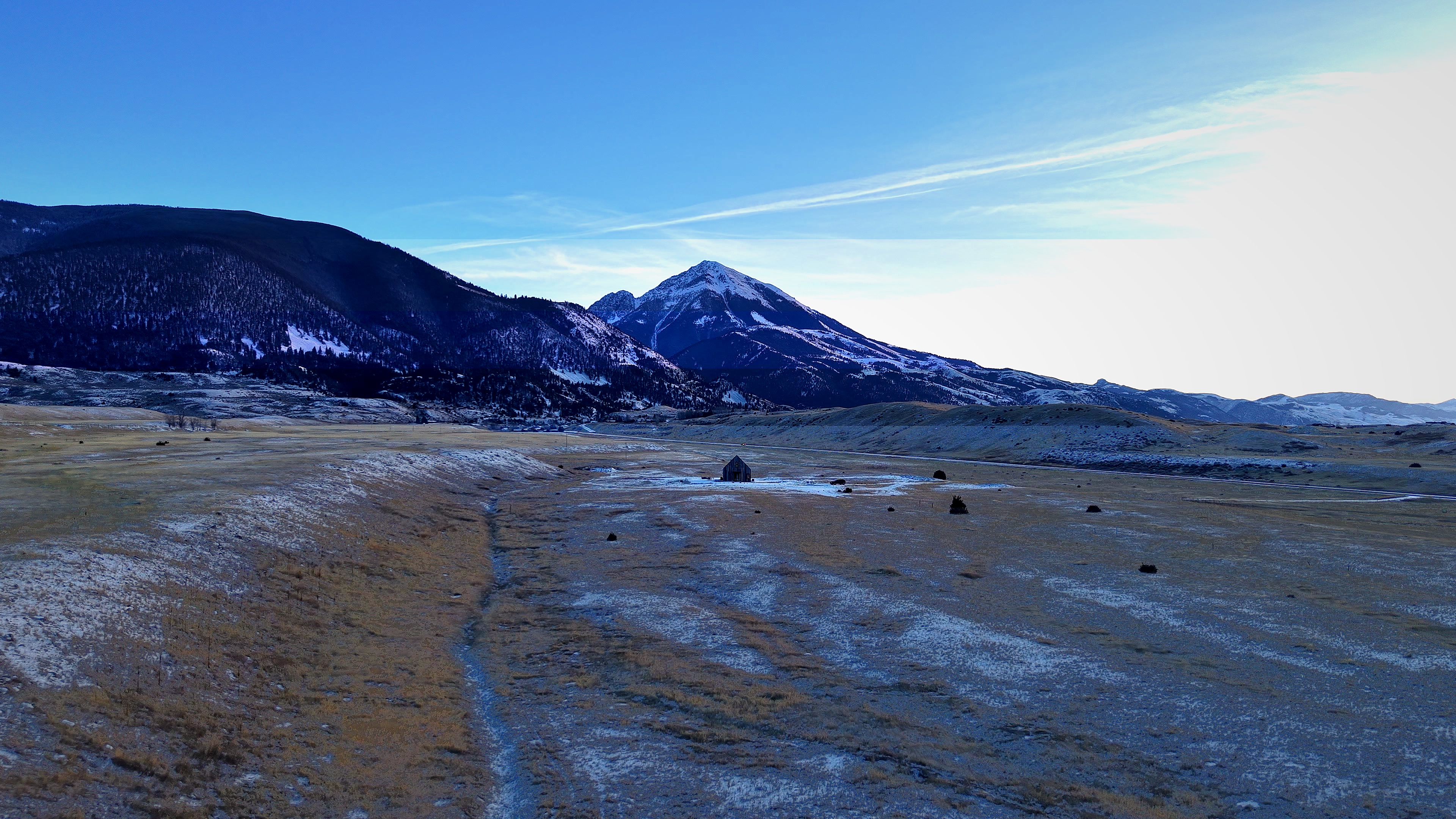 Glass House Montana in winter, snow on the surrounding peaks